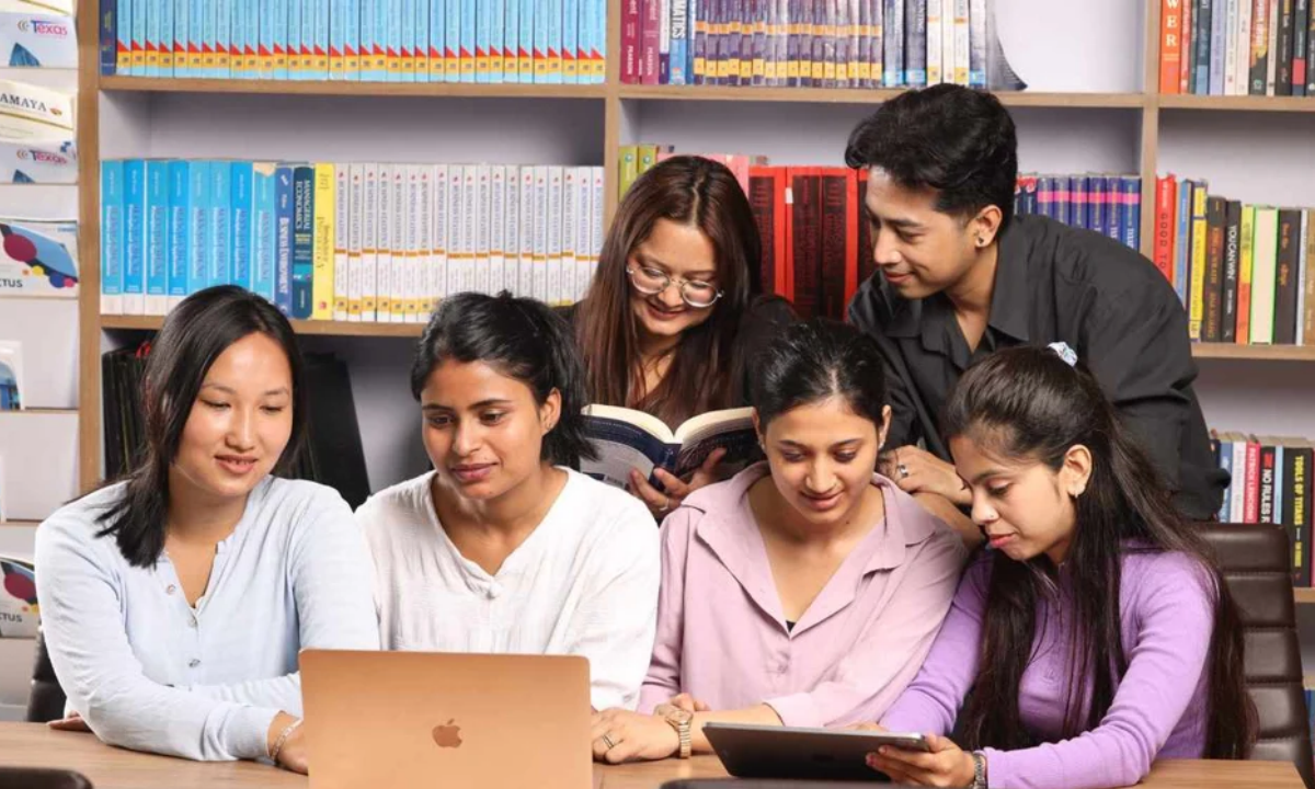 group of young people watching Highest-Paying Jobs After BBA in Nepal on laptop